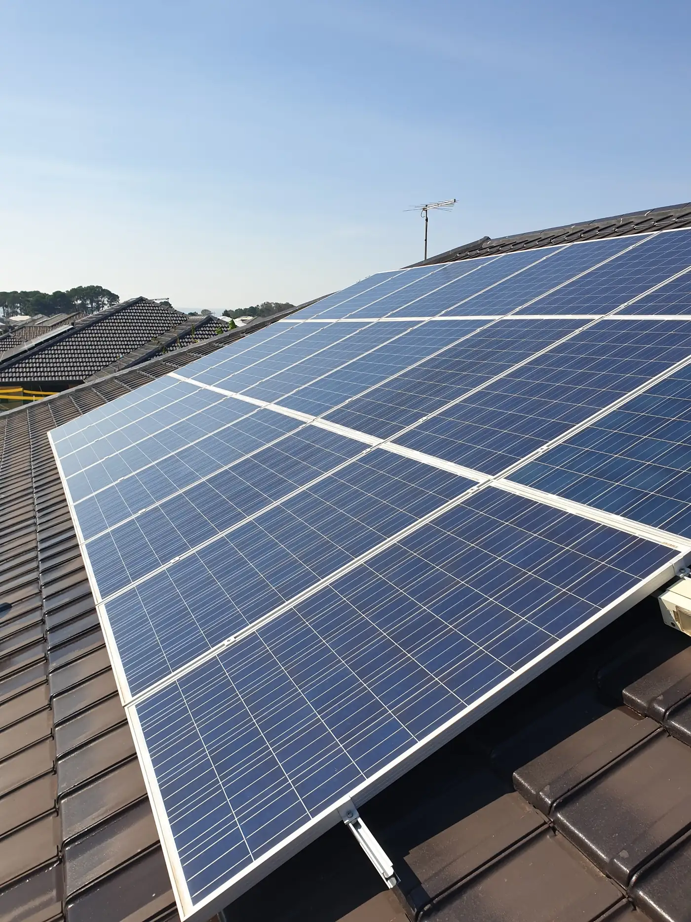 Clean solar panels on a dark tiled roof after a pure water clean in Perth