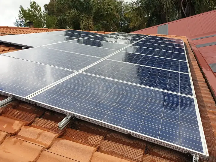 Solar panel bird proofing mesh fitted on a terracotta tiled roof