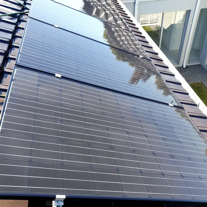 A dusty solar panel next to a freshly cleaned panel showing the difference
